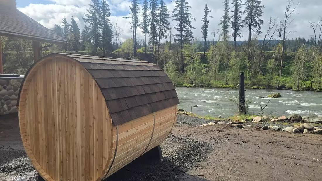 Barrel sauna at the river's edge