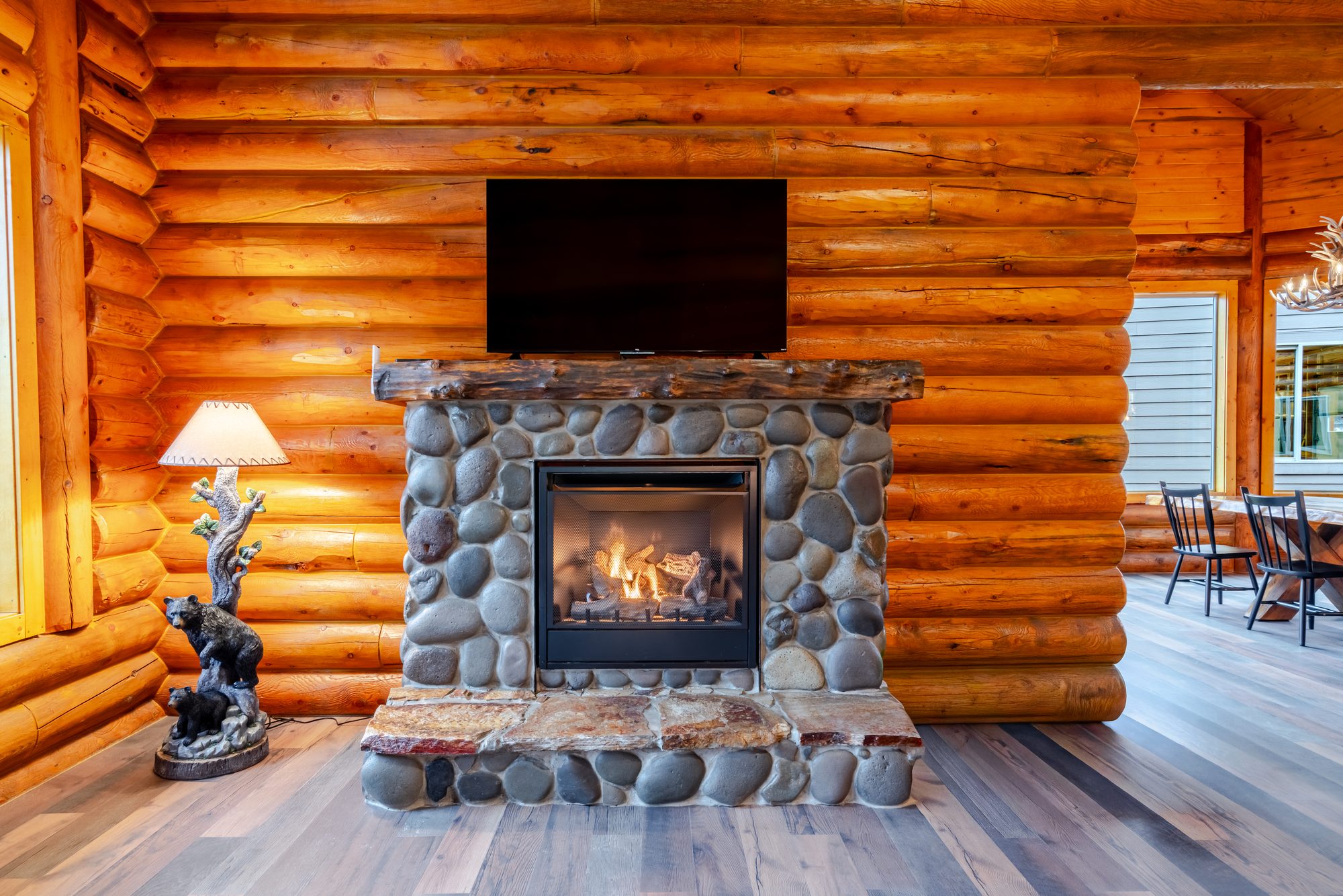 The great room — floor-to-ceiling stone fireplace and timber beams